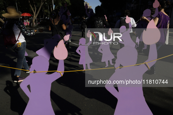 Mothers, relatives of missing persons and victims of femicide, feminist collectives, and various organizations hold silhouettes while protes...