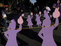 Mothers, relatives of missing persons and victims of femicide, feminist collectives, and various organizations hold silhouettes while protes...