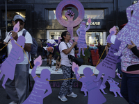 Mothers, relatives of missing persons and victims of femicide, feminist collectives, and various organizations hold silhouettes while protes...