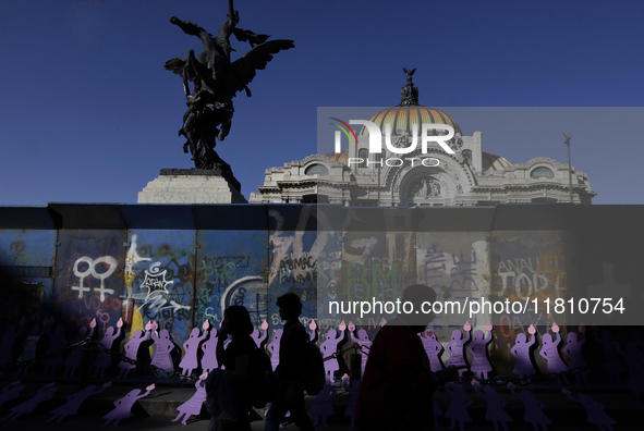 Silhouettes of mothers, relatives of missing persons and victims of femicide, feminist collectives, and various organizations protest outsid...