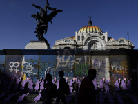 Silhouettes of mothers, relatives of missing persons and victims of femicide, feminist collectives, and various organizations protest outsid...