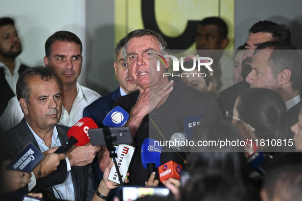 Former Brazilian President Jair Bolsonaro speaks to the press after arriving at Brasilia airport in Brasilia, Brazil, on November 25, 2024....