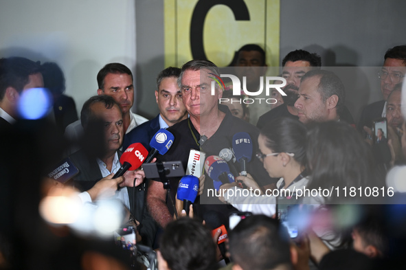 Former Brazilian President Jair Bolsonaro speaks to the press after arriving at Brasilia airport in Brasilia, Brazil, on November 25, 2024....