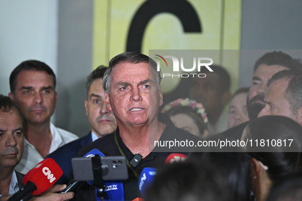 Former Brazilian President Jair Bolsonaro speaks to the press after arriving at Brasilia airport in Brasilia, Brazil, on November 25, 2024....