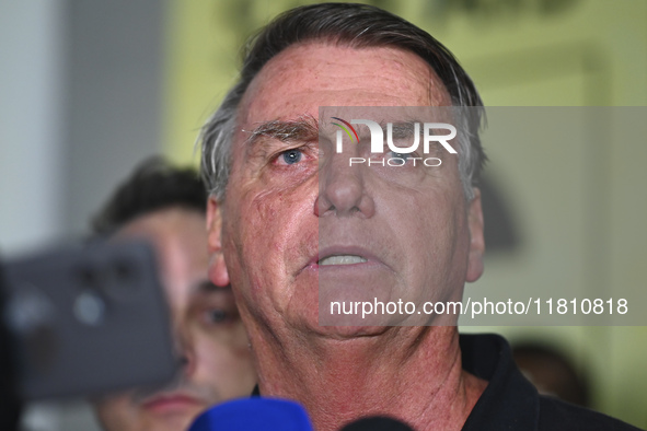 Former Brazilian President Jair Bolsonaro speaks to the press after arriving at Brasilia airport in Brasilia, Brazil, on November 25, 2024....