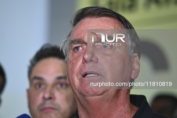 Former Brazilian President Jair Bolsonaro speaks to the press after arriving at Brasilia airport in Brasilia, Brazil, on November 25, 2024....