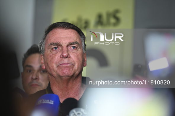 Former Brazilian President Jair Bolsonaro speaks to the press after arriving at Brasilia airport in Brasilia, Brazil, on November 25, 2024....