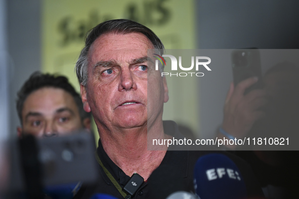 Former Brazilian President Jair Bolsonaro speaks to the press after arriving at Brasilia airport in Brasilia, Brazil, on November 25, 2024....