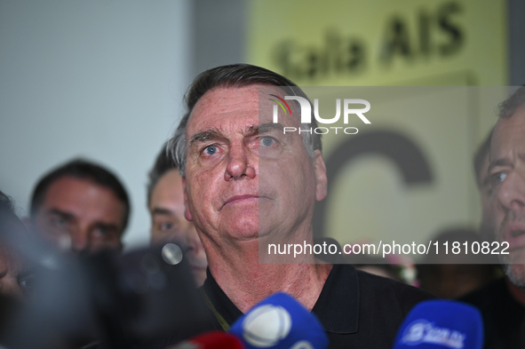 Former Brazilian President Jair Bolsonaro speaks to the press after arriving at Brasilia airport in Brasilia, Brazil, on November 25, 2024....