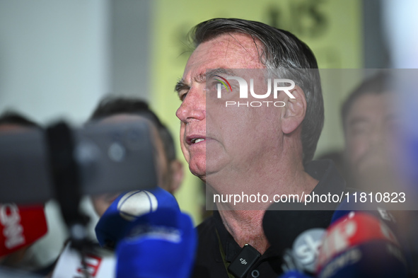 Former Brazilian President Jair Bolsonaro speaks to the press after arriving at Brasilia airport in Brasilia, Brazil, on November 25, 2024....