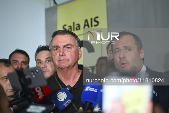 Former Brazilian President Jair Bolsonaro speaks to the press after arriving at Brasilia airport in Brasilia, Brazil, on November 25, 2024....