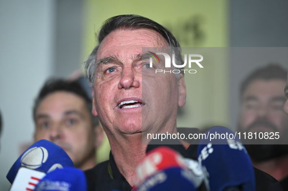 Former Brazilian President Jair Bolsonaro speaks to the press after arriving at Brasilia airport in Brasilia, Brazil, on November 25, 2024....