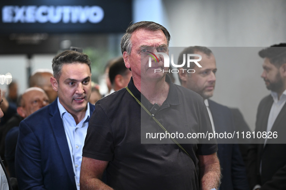 Former Brazilian President Jair Bolsonaro speaks to the press after arriving at Brasilia airport in Brasilia, Brazil, on November 25, 2024....