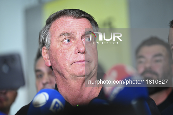 Former Brazilian President Jair Bolsonaro speaks to the press after arriving at Brasilia airport in Brasilia, Brazil, on November 25, 2024....