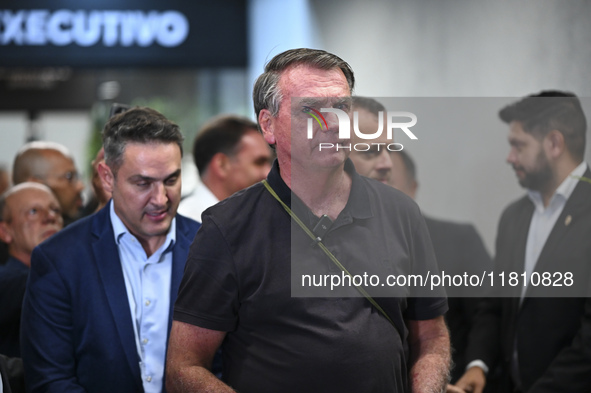 Former Brazilian President Jair Bolsonaro speaks to the press after arriving at Brasilia airport in Brasilia, Brazil, on November 25, 2024....