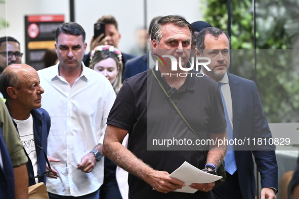 Former Brazilian President Jair Bolsonaro speaks to the press after arriving at Brasilia airport in Brasilia, Brazil, on November 25, 2024....