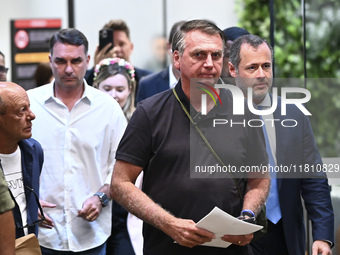 Former Brazilian President Jair Bolsonaro speaks to the press after arriving at Brasilia airport in Brasilia, Brazil, on November 25, 2024....