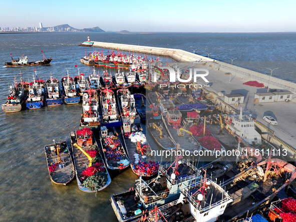 Fishing boats berth in the harbor to take shelter from the cold wave and wind at the central fishing port of Liandao in Lianyungang, Jiangsu...