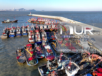 Fishing boats berth in the harbor to take shelter from the cold wave and wind at the central fishing port of Liandao in Lianyungang, Jiangsu...