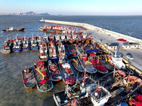 Fishing boats berth in the harbor to take shelter from the cold wave and wind at the central fishing port of Liandao in Lianyungang, Jiangsu...