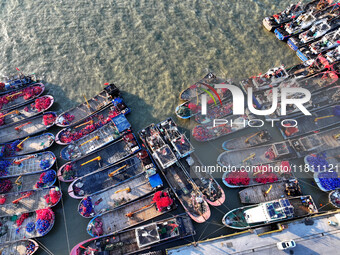 Fishing boats berth in the harbor to take shelter from the cold wave and wind at the central fishing port of Liandao in Lianyungang, Jiangsu...