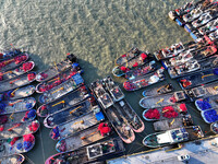 Fishing boats berth in the harbor to take shelter from the cold wave and wind at the central fishing port of Liandao in Lianyungang, Jiangsu...