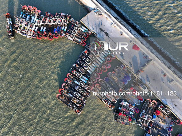 Fishing boats berth in the harbor to take shelter from the cold wave and wind at the central fishing port of Liandao in Lianyungang, Jiangsu...