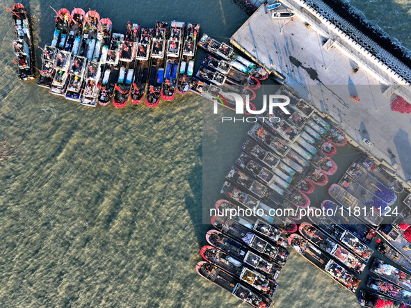 Fishing boats berth in the harbor to take shelter from the cold wave and wind at the central fishing port of Liandao in Lianyungang, Jiangsu...