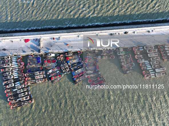 Fishing boats berth in the harbor to take shelter from the cold wave and wind at the central fishing port of Liandao in Lianyungang, Jiangsu...