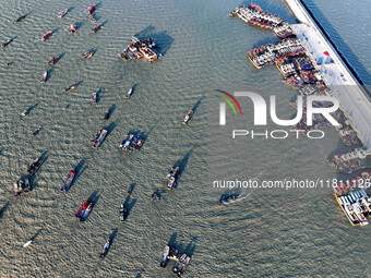 Fishing boats berth in the harbor to take shelter from the cold wave and wind at the central fishing port of Liandao in Lianyungang, Jiangsu...