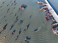 Fishing boats berth in the harbor to take shelter from the cold wave and wind at the central fishing port of Liandao in Lianyungang, Jiangsu...