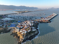 Fishing boats berth in the harbor to take shelter from the cold wave and wind at the central fishing port of Liandao in Lianyungang, Jiangsu...