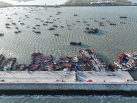 Fishing boats berth in the harbor to take shelter from the cold wave and wind at the central fishing port of Liandao in Lianyungang, Jiangsu...