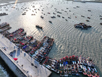 Fishing boats berth in the harbor to take shelter from the cold wave and wind at the central fishing port of Liandao in Lianyungang, Jiangsu...