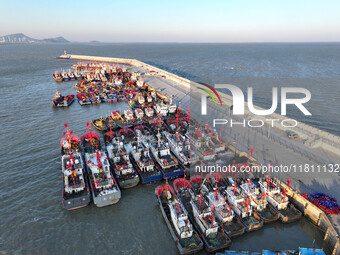 Fishing boats berth in the harbor to take shelter from the cold wave and wind at the central fishing port of Liandao in Lianyungang, Jiangsu...