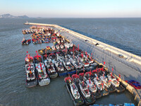 Fishing boats berth in the harbor to take shelter from the cold wave and wind at the central fishing port of Liandao in Lianyungang, Jiangsu...