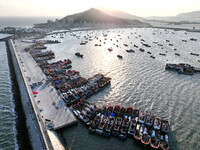 Fishing boats berth in the harbor to take shelter from the cold wave and wind at the central fishing port of Liandao in Lianyungang, Jiangsu...