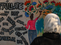 A college student looks at the graffiti on a wall in Srinagar, Jammu and Kashmir, on November 26, 2024. In total, 11.3% of the adult populat...