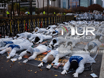 Members of the Korea Parents' Network for People with Disabilities perform the symbolic 'five-body prostration' protest in front of the Nati...