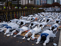 Members of the Korea Parents' Network for People with Disabilities perform the symbolic 'five-body prostration' protest in front of the Nati...