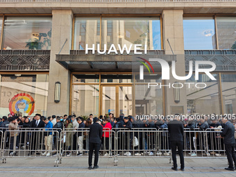 Customers line up outside Huawei's global flagship store to attend Huawei's Mate brand launch ceremony in Shanghai, China, on November 26, 2...