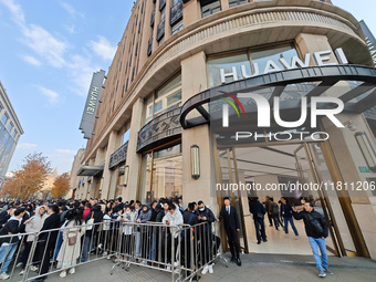 Customers line up outside Huawei's global flagship store to attend Huawei's Mate brand launch ceremony in Shanghai, China, on November 26, 2...