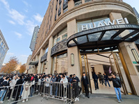 Customers line up outside Huawei's global flagship store to attend Huawei's Mate brand launch ceremony in Shanghai, China, on November 26, 2...