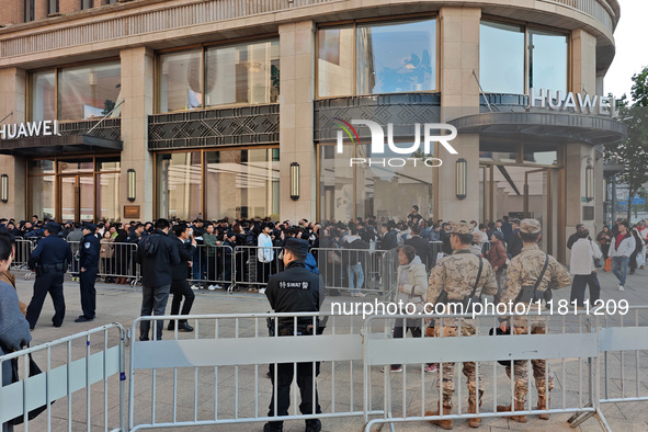 Customers line up outside Huawei's global flagship store to attend Huawei's Mate brand launch ceremony in Shanghai, China, on November 26, 2...