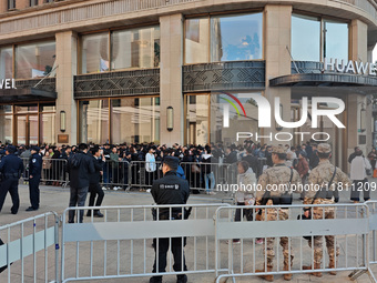 Customers line up outside Huawei's global flagship store to attend Huawei's Mate brand launch ceremony in Shanghai, China, on November 26, 2...