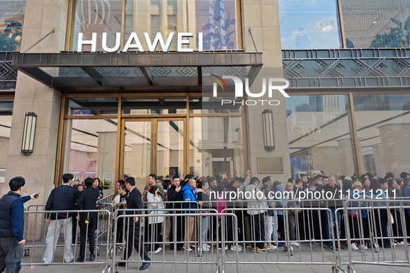 Customers line up outside Huawei's global flagship store to attend Huawei's Mate brand launch ceremony in Shanghai, China, on November 26, 2...