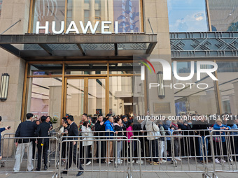 Customers line up outside Huawei's global flagship store to attend Huawei's Mate brand launch ceremony in Shanghai, China, on November 26, 2...