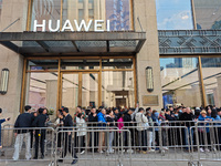 Customers line up outside Huawei's global flagship store to attend Huawei's Mate brand launch ceremony in Shanghai, China, on November 26, 2...