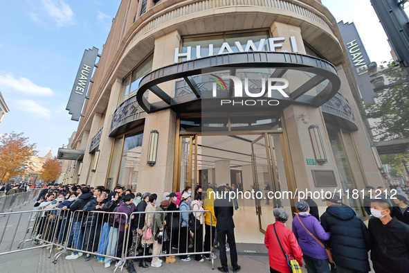 Customers line up outside Huawei's global flagship store to attend Huawei's Mate brand launch ceremony in Shanghai, China, on November 26, 2...