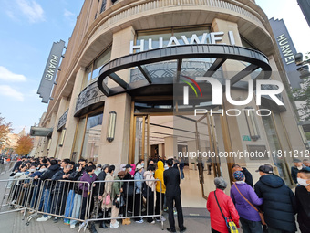 Customers line up outside Huawei's global flagship store to attend Huawei's Mate brand launch ceremony in Shanghai, China, on November 26, 2...